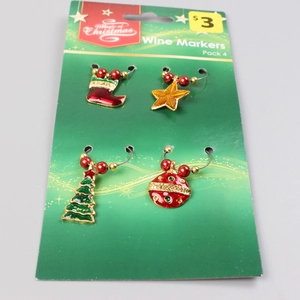 Set of 4 Christmas wine glass markers with festive charms on a green display card