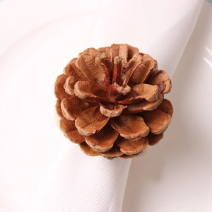 Macro shot of natural pine cone napkin ring with realistic texture on a white cloth