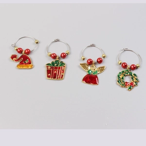 Detailed view of Christmas wine glass charms including hat, gift box, and wreath designs