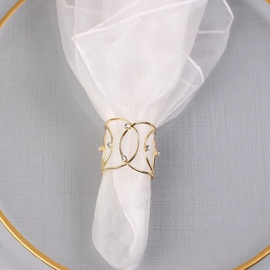 Macro shot of gold-plated woven napkin ring with sparkling rhinestone accents