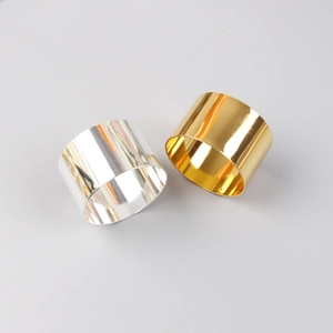 Close-up of gold and silver polished metal napkin rings with mirror finish surface