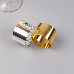 Close-up of polished gold and silver metal napkin rings with reflective mirror finish