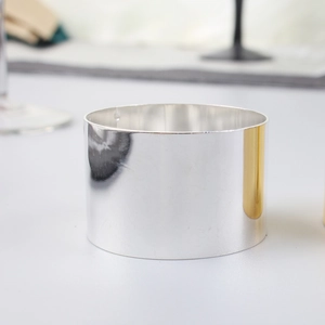 Polished silver metal napkin ring with a sleek minimalist mirror finish for dining decor