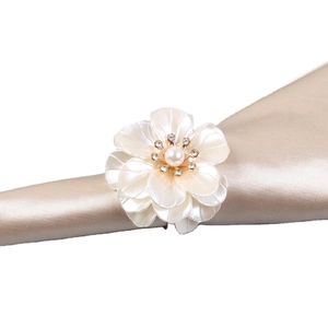 European pearl flower napkin ring with acrylic petals and rhinestones on champagne silk