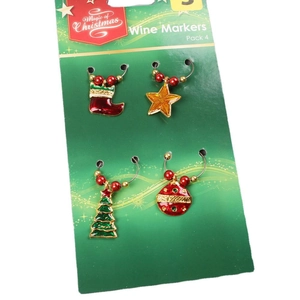 Set of 4 Christmas wine glass markers with tree, star, and boot charms on white background