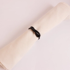 Minimalist black bow knot metal napkin ring with cream white napkin for table decor