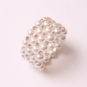 Detail of elegant multi-row pearl and rhinestone napkin ring for wedding decor