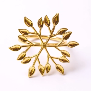 Golden leaf starburst napkin ring with metallic textured finish on white background