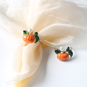 Orange pumpkin napkin rings with green enamel leaf and pearl accent for fall table decor