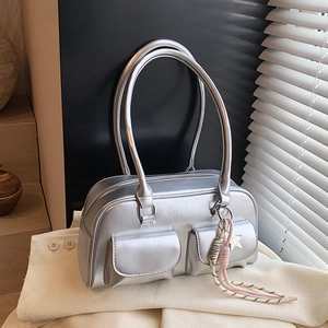 Silver metallic handbag with dual front pockets and star pendant for chic commuting