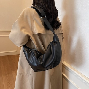 Large black matte leather crescent crossbody bag with stylish knot strap for women