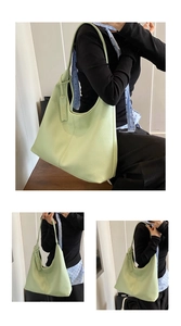 Detail view of mint green hobo tote bag with pebble leather texture and shoulder strap