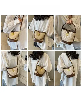 Detail view of woven straw bucket bag with leather trim and adjustable crossbody strap