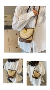 Close-up of a woven straw bucket bag with dark brown leather trim and a gold twist lock
