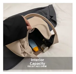 Internal capacity of the cream faux leather tote bag showing phone and cosmetics