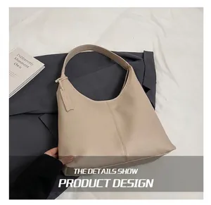 Detailed view of beige litchi grain leather texture and hobo bag decorative vertical stitching