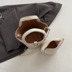Chic off-white faux leather bucket bag set with chain strap and matching coin purse