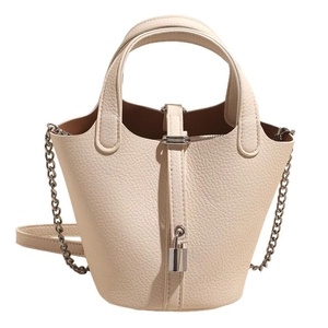 Chic cream leather bucket bag with silver lock and chain strap on white background