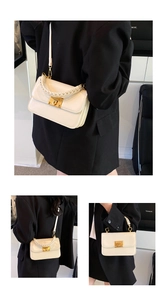 Detail of cream square bag featuring cylindrical woven handle and gold metal lock buckle