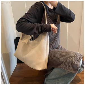 Close-up of cream lychee pattern leather on a large minimalist tote bag for women