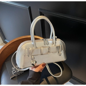 Détail du sac à main argenté métallisé avec breloque coeur et boucle décorative chic