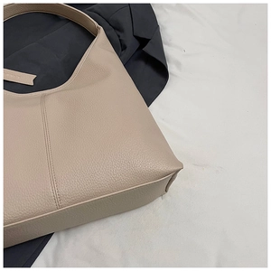Detail of beige litchi grain tote bag showing refined texture and Verimate brand tag