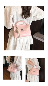 Detail of pink soft leather tote bag with silver metal lock and woven strap accent