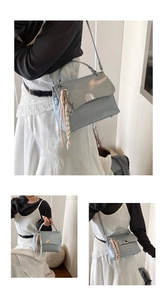 Detail of light blue faux leather handbag with silver lock and decorative silk scarf
