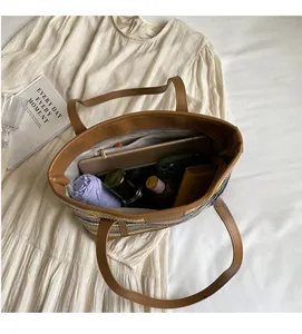 Interior view showing large storage capacity of the colorful woven straw tote bag