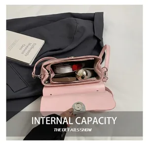 Detailed view of pink leather bag interior with zipper pockets and magnetic clasp