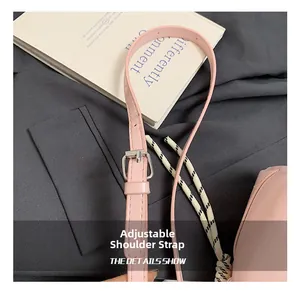 Detailed shot of the pink leather adjustable shoulder strap with silver metal buckle