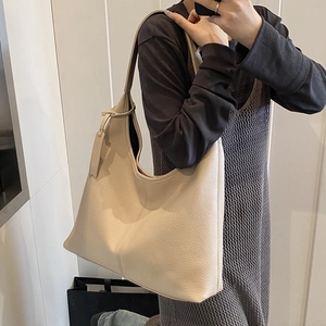 Minimalist cream hobo shoulder bag with litchi texture grain in a soft leather style