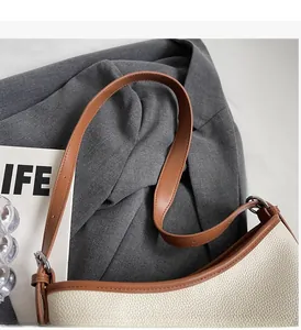 Detail of off-white lychee texture tote bag with brown slim strap and oil edge finish