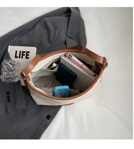Macro shot of large interior space and side pocket of the cream textured leather tote bag