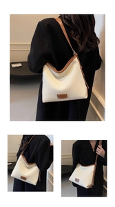 Detail of minimalist cream leather tote bag with brown contrast trim and metal rivets