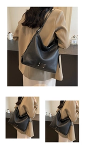 Detail of black lychee grain leather hobo bag with silver rivet and adjustable strap