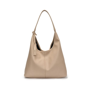 Minimalist apricot pebbled leather hobo tote bag with shoulder strap and brand tag