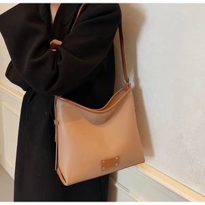 Detail view of khaki brown pebble grain tote bag with contrast stitching on shoulder
