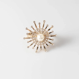 Luxurious gold flower napkin ring with a white pearl and sparkling crystals center