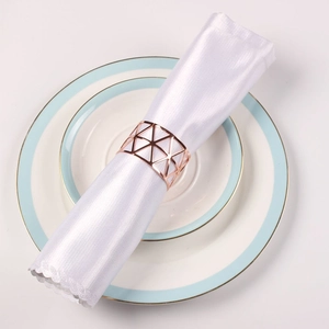 Rose gold geometric hollow triangle napkin ring with white lace satin napkin on china plates