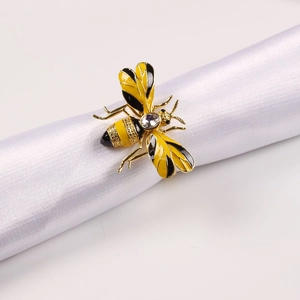 Enamel bee napkin ring with golden metal finish and sparkling crystal stone accent
