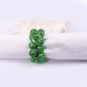 Detailed view of green rhinestone beaded napkin ring with a sparkling crystal finish