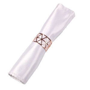 Rose gold metal napkin ring with hollow geometric triangle design on white satin napkin