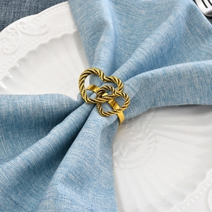 Golden double heart napkin rings with twisted metal texture for Valentine's table decor