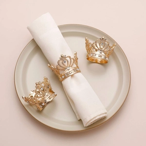 Elegant gold crown napkin rings with sparkling rhinestones for wedding banquet tables