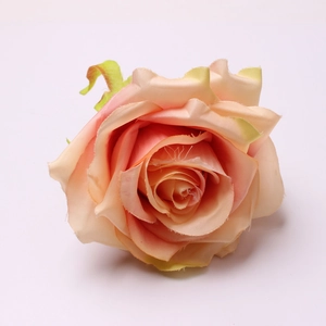 Macro shot of artificial rose napkin ring with champagne pink silk petals and fabric texture