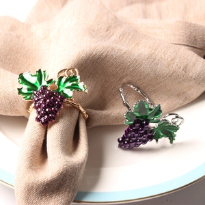 Grape napkin ring set with purple beads and green leaves on gold and silver metal bases