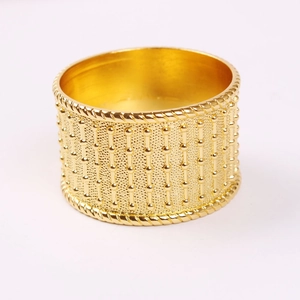 Golden metal napkin ring with vertical beaded texture and twisted rope edges for hotel banquet