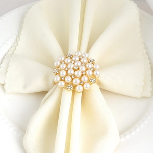 Floral pearl napkin ring with rhinestones on a gold base for elegant table settings