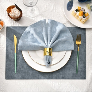 Golden butterfly napkin ring with blue fabric placemat for elegant table decoration